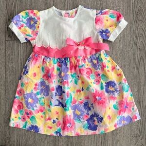 Vintage baby girl floral dress with a white bodice and a pink bow